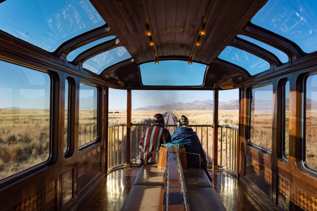 Antiplano, Peru – Enjoying the observation deck of the PeruRail Titicaca Train, crossing the antiplano on the journey from Puno to Cusco, Peru